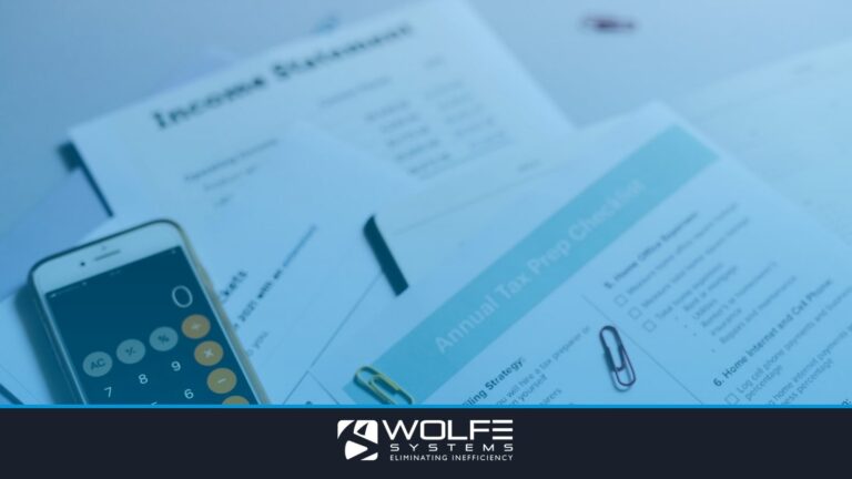 Tax preparation setup with documents, smartphone calculator, and checklist.