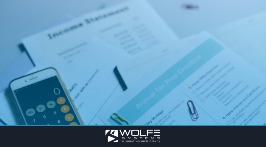 Tax preparation setup with documents, smartphone calculator, and checklist.