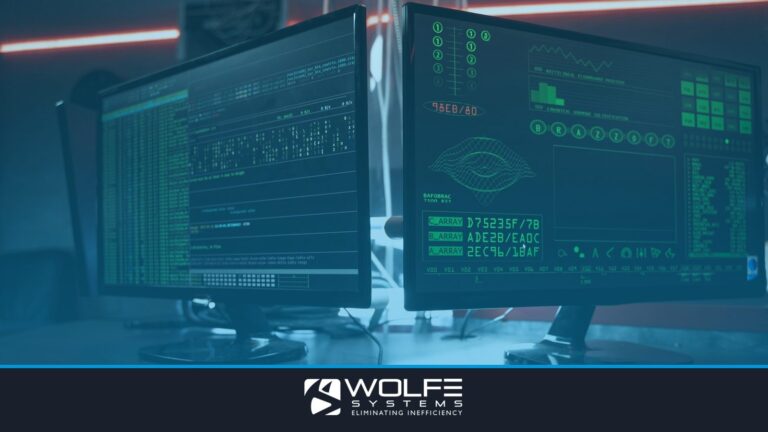 Close-up of dual computer monitors with green coding interfaces in a dark room, highlighting cyber security themes.
