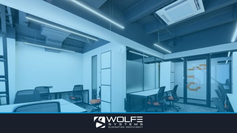White tables with armchairs in modern spacious workspace with white cupboards and glass door in office of contemporary b