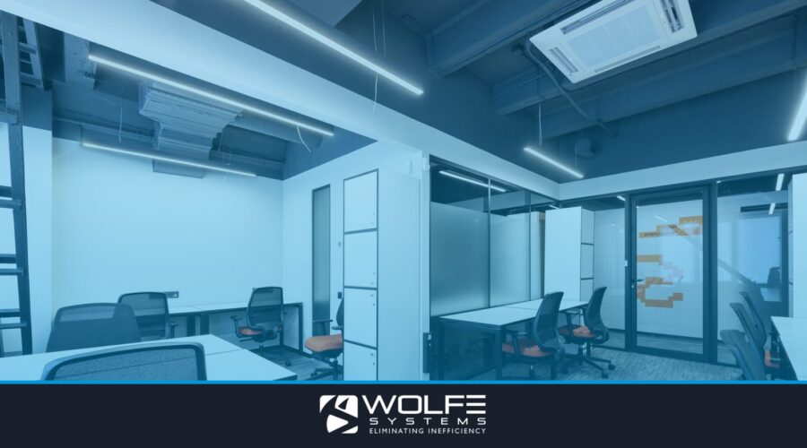 White tables with armchairs in modern spacious workspace with white cupboards and glass door in office of contemporary b