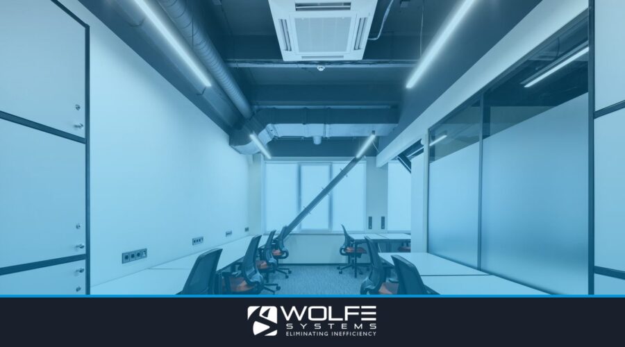 White desks with comfortable colorful chairs placed in spacious workspace with window and glass partitions in contempora