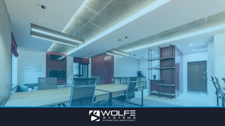 Interior of modern workplace with wooden tables and chairs under lamps next to shelves and door