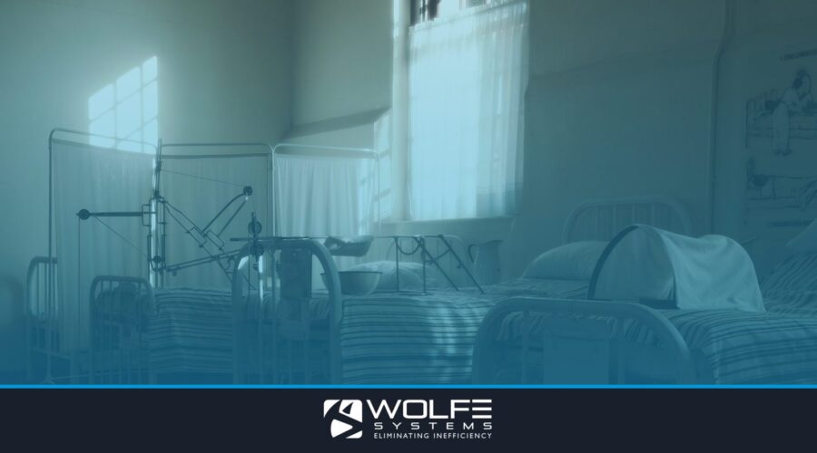 Dimly lit vintage hospital room featuring empty beds and medical equipment, creating a nostalgic atmosphere.