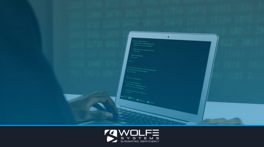A focused adult working on a laptop demonstrates modern cybersecurity and coding skills indoors.