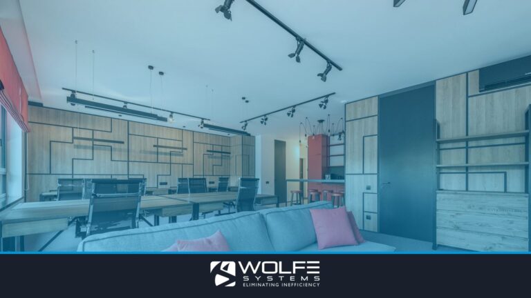 Creative design of workspace with couch between tables and armchairs under ceiling with hanging lamps in daytime