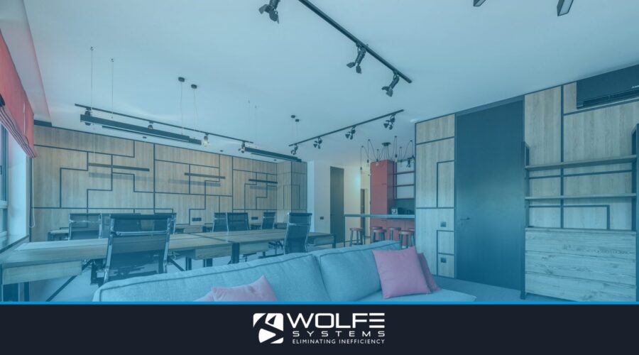 Creative design of workspace with couch between tables and armchairs under ceiling with hanging lamps in daytime