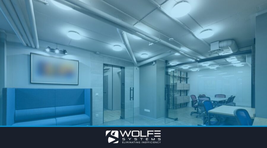Interior of contemporary spacious workspace furnished with comfortable sofa and blue office chairs at tables